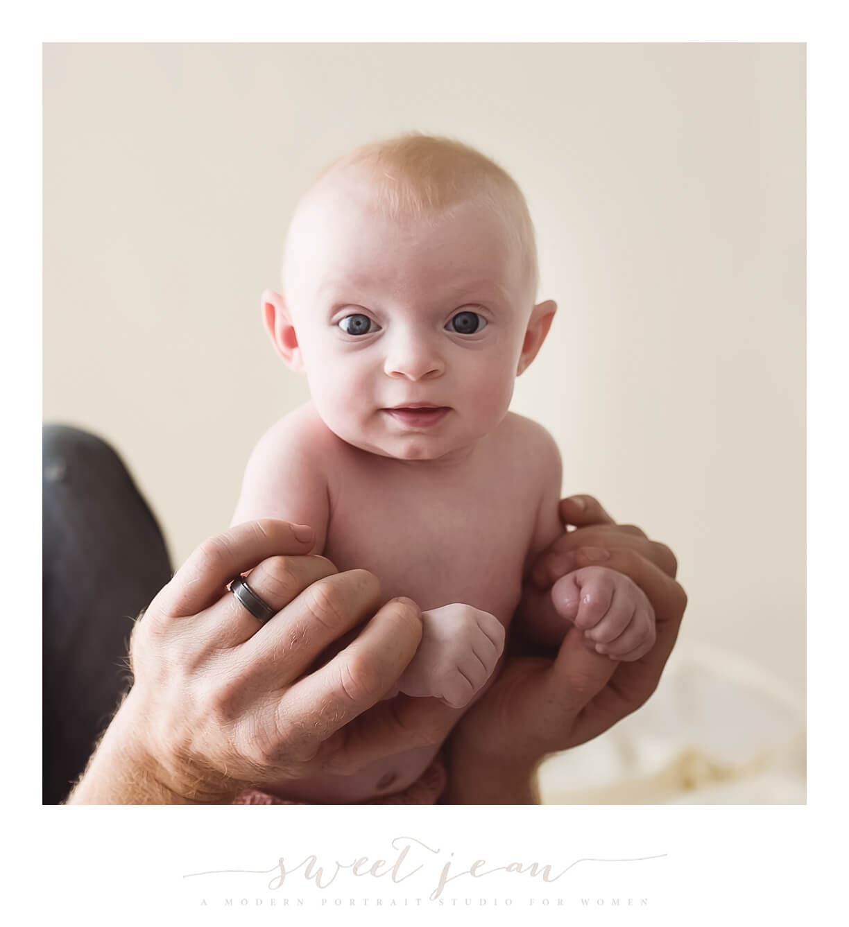 baby girl in daddys hands