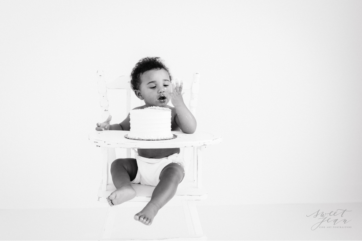 baby in vintage highchair eating cake roseville baby photographer