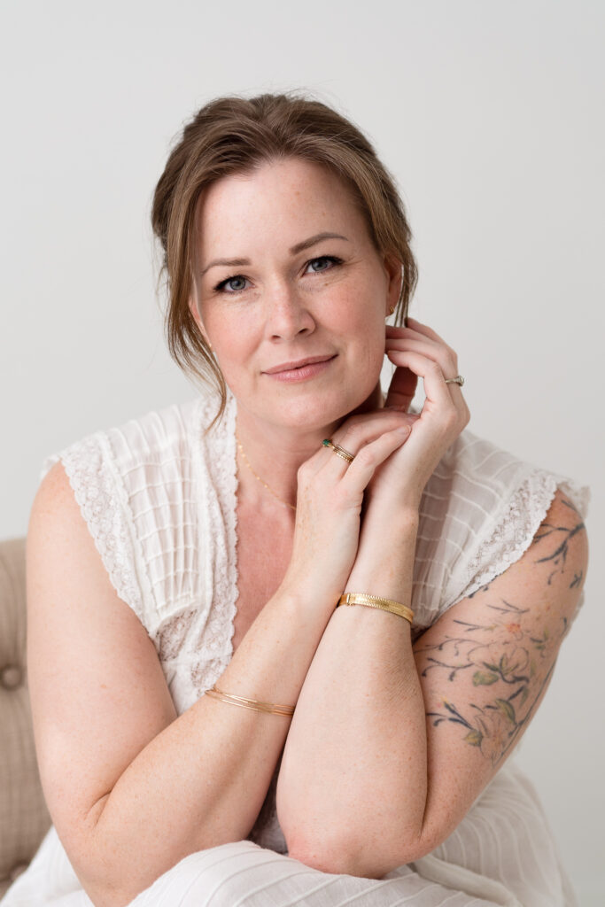 Portrait of a white woman with a tattoo.